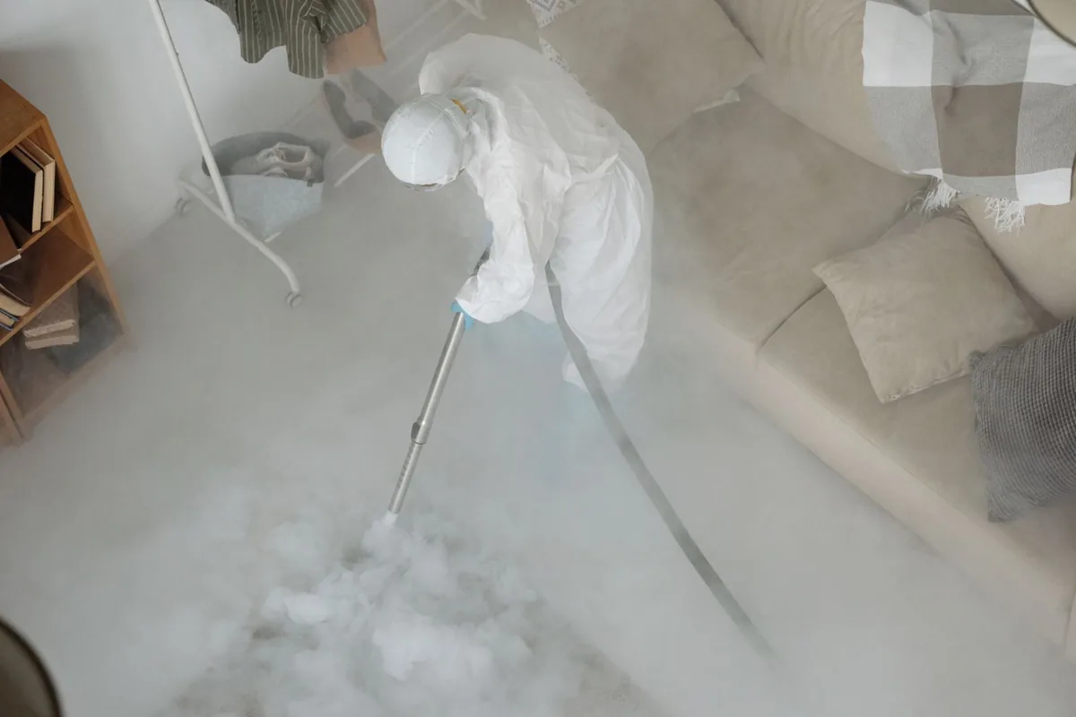 Biohazard cleanup technician in protective equipment, Macon, MO